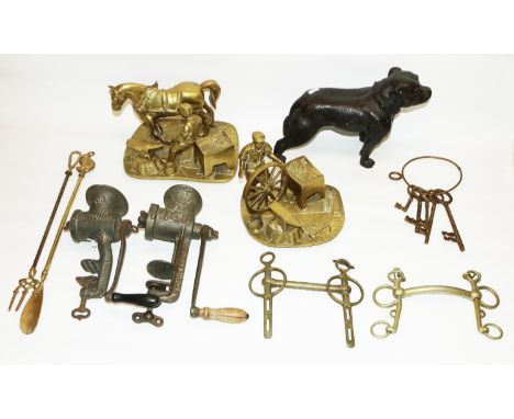 Brass model of a farrier, brass model of a blacksmith, two equestrian driving bits, two British-made meat mincers, enamel kit