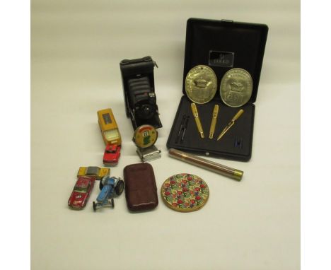 Two Covent Garden market embossed plaques, Jakko pen set, Kodak no.1 pocket Kodak Jr, cigar case, diecast vehicles, powder co