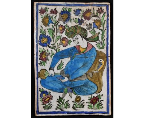 A Persian Islamic rectangular tile or panel, painted in the typical Qajar manner with a figure holding a water vessel, 35cm x