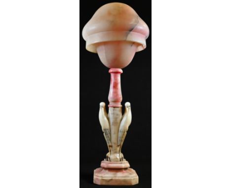 A French Art Deco period rouge-blushed alabaster table lamp, domed shade, the pillar carved as a pair of birds, canted square