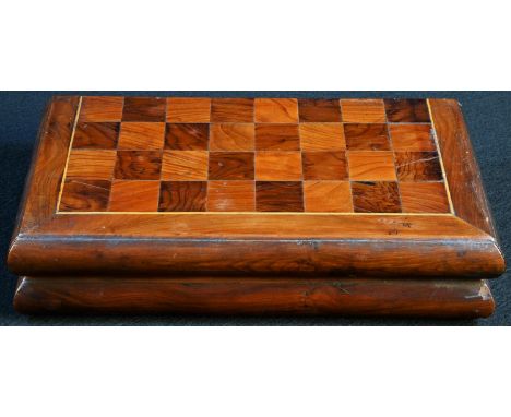 A 19th century yew travelling chess board, the parquetry field outlined with boxwood stringing, hinged to the centre, the int