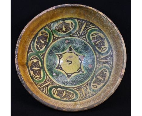 Antiquities - a 10th century East Persian terracotta flared bowl, painted and decorated in the Islamic taste with a star-shap