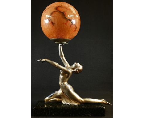 An Art Deco design silvered metal figural table lamp, as a scantily clad dancer balancing a ball, globular crackle-glass shad