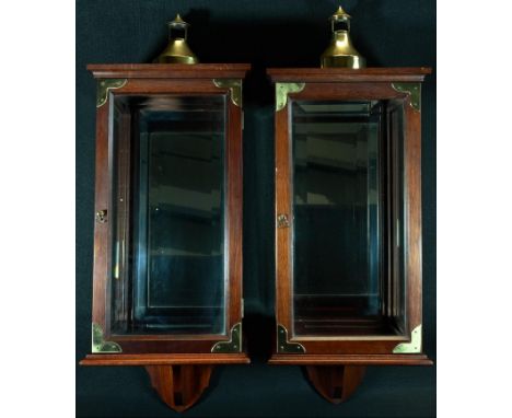 A pair of George III style brass mounted mahogany candle lantern cabinets, ogee domed chimneys, bevelled panes, axehead handl