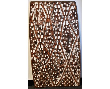 Tribal Art - an Asmat rectangular panel, carved and decorated in earth and white pigments with spirits, 113.5cm x 64.5cm wide