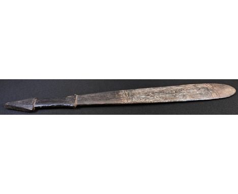 Tribal Art - a Massim club, the spatulate blade carved with a panel of swirling geometric motifs picked out in lime, stepped 