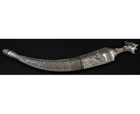 A Middle Eastern silver coloured metal jambiya dagger, 28.5cm curved blade with diapers to spine, the scabbard and grip profu