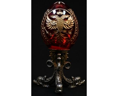 An early 20th century ruby glass egg, cut and highlighted in gilt with the Russian Imperial double-headed eagle, the silver p