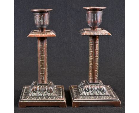 A pair of Victorian Grecian Revival coppered candlesticks, fluted Campana sconces, square drip pans with a lotus frieze, colu