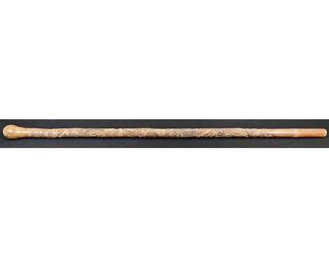 A Japanese bamboo walking stick, carved in relief with ferocious dragons amongst scrolling clouds, 89cm long, Meiji period 