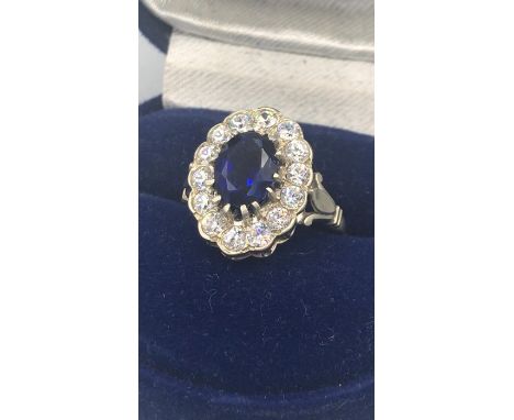 A Sapphire and White stone ring.