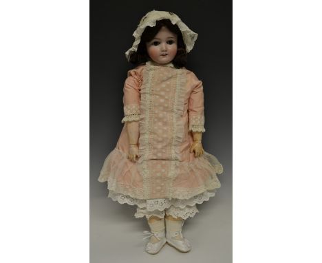 A Schoenau & Hoffmeister bisque head doll, sleeping brown glass eyes, open red lips revealing four large top teeth,   painted
