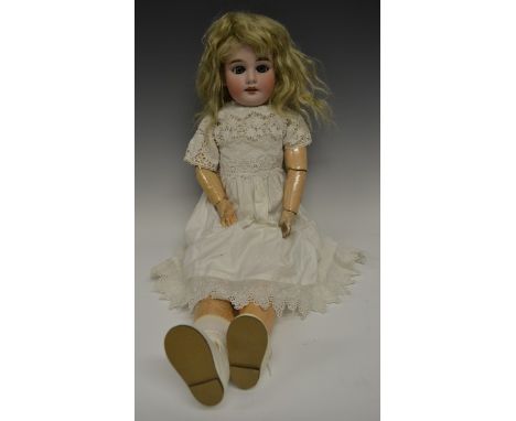 An Armand & Marseille bisque head and partially fixed ball jointed bodied doll, sleeping blue glass eyes, painted features in