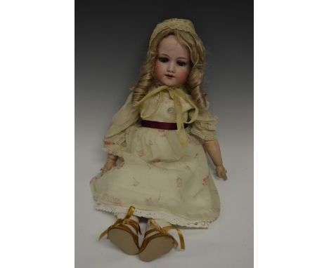 An Armand & Marseille bisque head doll, sleeping blue glass eyes, open red lips revealing four large top teeth,   painted fea