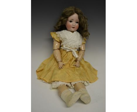 A Schoenau & Hoffmeister bisque head doll, fixed brown eyes, open red lips revealing four large top teeth,   painted features