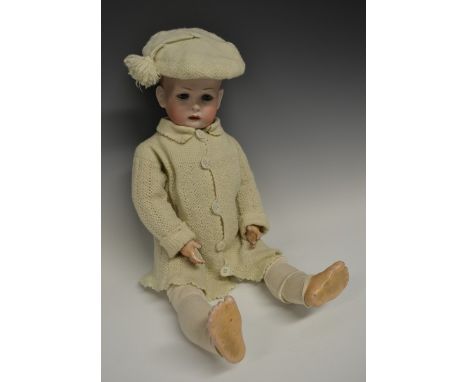 A Bruno Schmidt "Tommy Tucker" doll,  bisque porcelain dome head and painted side part hair, pink open mouth, grey blue glass