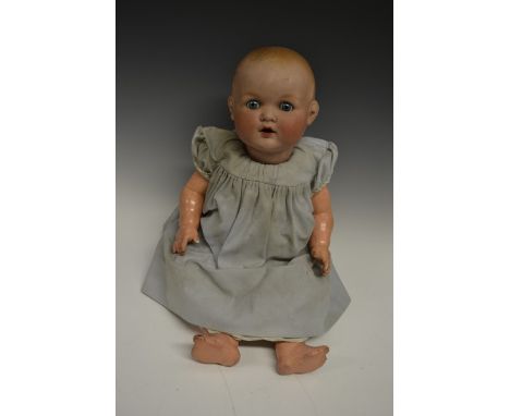 Armand Marseille - a German porcelain head baby doll. moulded painted hair, fixed blue eyes, open mouth, impressed A.M German