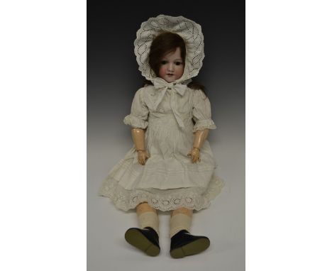 An Armand & Marseille bisque head doll, sleeping brown glass eyes, open red lips revealing four large top teeth,   painted fe