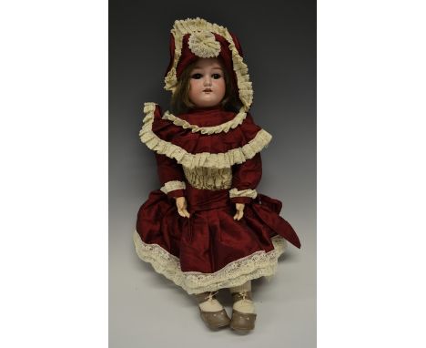 A German bisque head doll, sleeping brown glass eyes, open red lips revealing four large top teeth,   painted features, weari