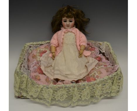 A Simon & Halbig for Louis Lindner & Sohne bisque head girl doll with brown glass sleeping eyes, open mouth and teeth, pierce