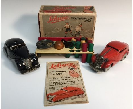 A Schuco tinplate clockwork Telesteering Car No.3000 - black, with key, accessories, control wire etc, boxed;  a similar two 