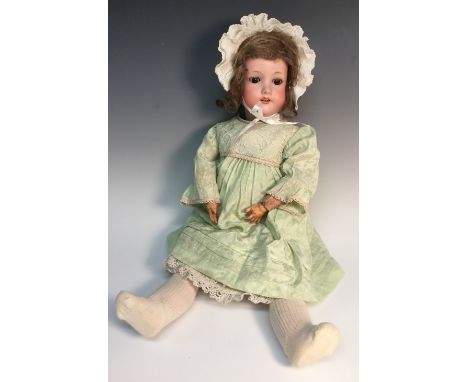 An Armand & Marseille bisque head doll, sleeping brown glass eyes, open red lips revealing four large top teeth,   painted fe