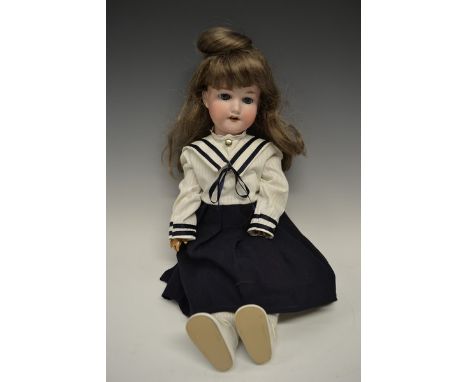 An Armand & Marseille bisque head doll, sleeping blue glass eyes, open red lips revealing four large top teeth,   painted fea