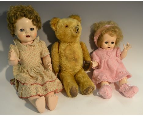 A Pedigree walking doll, open close eyes, light brown hair, original dress, 55cm high; a Pedigree baby doll. open close eys, 