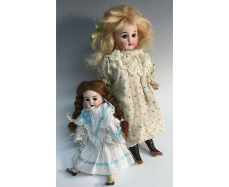 A German bisque bead doll, wih brown eyes, open mouth with four upper teeth, 27cm high;  another,  18.5cm high (2)