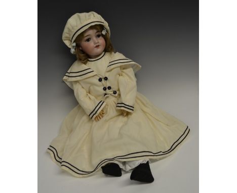 An Armand & Marseille bisque head doll, sleeping blue glass eyes, open red lips revealing four large top teeth,   painted fea