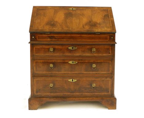 A yew, crossbanded and feather-banded bureau,18th century, the rectangular top above a fall front, enclosing a fitted interio