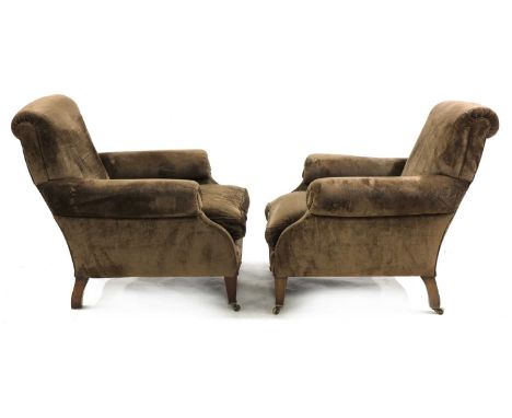 A pair of easy armchairs,first half of the 20th century, each upholstered in velvet, with a scrolling back, barrel arms and a