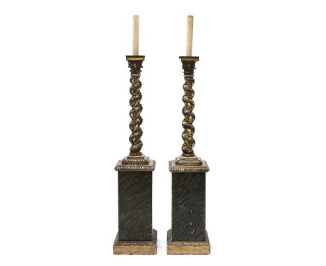 A pair of carved wooden lamp standards,c.1850, Italian, each in the form of a Corinthian column with a twisting support entwi