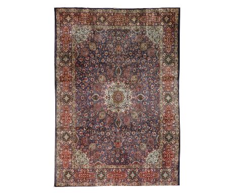 A Persian Tabriz rug, 20th century, the field woven with a central medallion within scrolling floral and foliate motifs, on a