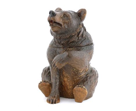 A Black Forest carved wooden bear tobacco jar,mid-19th century, Swiss, the head and shoulders forming a hinged cover, with gl