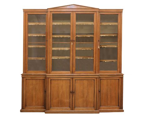 A Victorian rosewood breakfront bookcase,mid-19th century, the architectural pediment over glazed doors opening to reveal adj