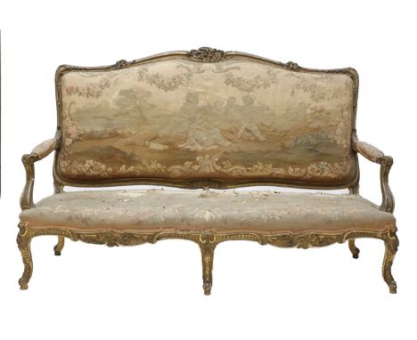 A Louis XV-style carved giltwood canape,mid-19th century, French, the frame ornately carved with scrolls and foliage, upholst