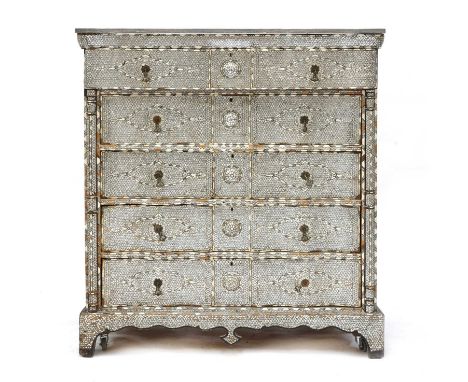A Syrian ebonised, mother-of-pearl and bone inlaid tall chest of drawers,20th century, the serpentine marble top above five l