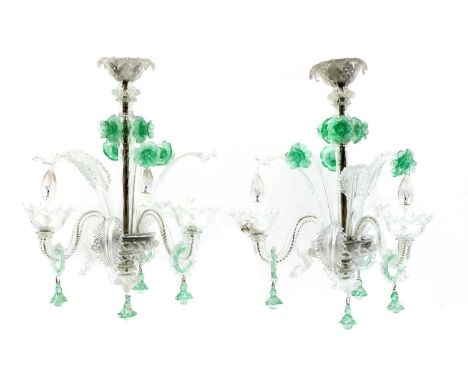 A pair of Murano glass chandeliers, the three-light scrolling branches interspersed by hot-worked scrolling leaf and green gl