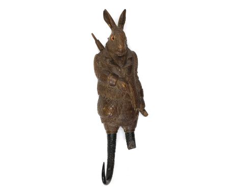 A Black Forest carved linden wood and horn musical hook,19th century, in the form of a hare in traditional hunting garb, fitt