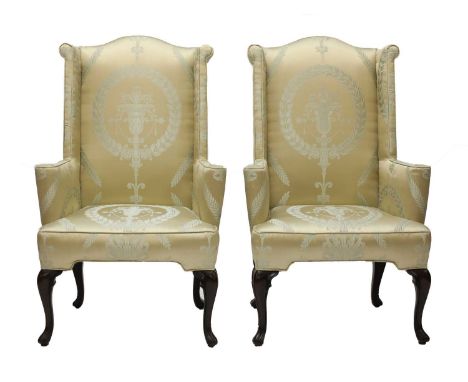 A pair of wingback armchairs,20th century, in the 18th century style, upholstered in silk damask and raised on cabriole suppo