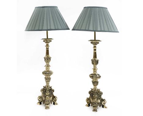 A matched pair of Dutch-style brass altar candlestick table lamps,20th century, each of traditional style with a leaf cast an