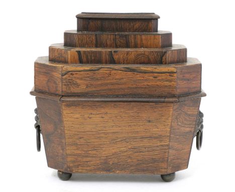 A Regency rosewood pincushion,in the form of a sarcophagus tea caddy, the stepped lid above a faceted body, raised on bun fee