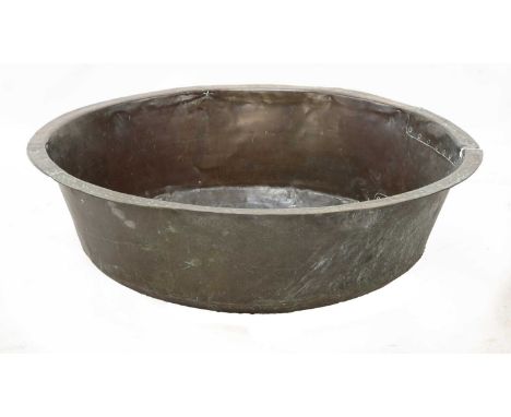 A riveted and patch repaired round brass bath,19th century,77cm diameter27cm highCondition report: Split to the rim, old knoc