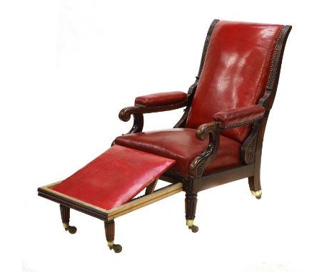 A rosewood reclining library armchair,  c.1840, by Jeanselme, the reclining back seat, arms and pull-out footrest upholstered