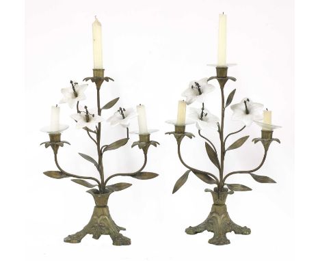 A pair of opaline glass and gilt metal three-light candelabra,20th century, each in the form of a lily, on a triform base,39c