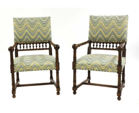 A pair of walnut armchairs,19th century, French, the upholstered backs with pierced gallery over the open arms with ball fini