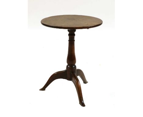 A small George III oak tripod table,the circular tilt-top above a turned baluster column and outswept pointed legs,47cm diame
