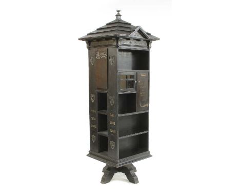 An American 'Tabard Inn Library' ebonised oak revolving bookcase,c.1902, of architectural form with a gabled roof above vario