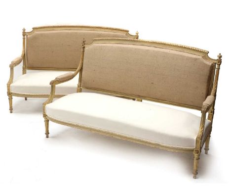 A pair of French Louis XVI-style painted and parcel-gilt settees,19th century, each with a shaped gadrooned top rail set with